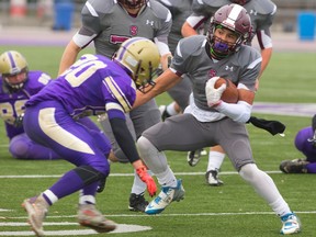 South running back Chase Brown jukes his way past Central?s Issac Rigby during their TVRA District senior football semifinal at TD Stadium on Thursday. Brown missed the second half, but his running mate Nick Morello scored three touchdowns in the Lions? 20-14 victory. (MIKE HENSEN, The London Free Press)