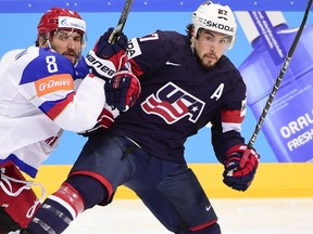 Forward Alexander Ovechkin (left) of Russia hits defender Justin Faulk of the U.S. during the semifinals at the World Championships on May 16, 2015 at the O2 Arena in Prague. (AFP PHOTO/JONATHAN NACKSTRAND)