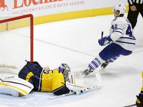 Toronto Maple Leafs centre Tyler Bozak (42) scores a goal against against Nashville Predators goalie Pekka Rinne Thursday, Nov. 12, 2015, in Nashville, Tenn. (AP Photo/Mark Humphrey)