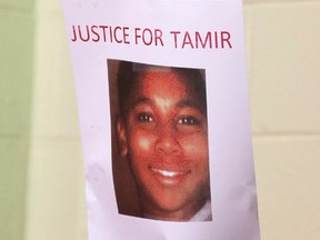 This Dec. 8, 2014 file photo shows a person holding up a sign for justice for Tamir Rice during a news conference in Cleveland. (AP Photo/Tony Dejak, File)