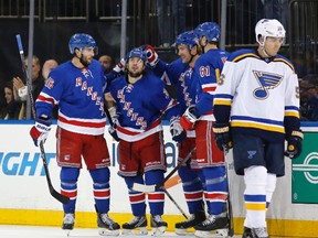 From left to right, New York Rangers center Derick Brassard (16) celebrates with right wing Mats Zuccarello, of Norway, defenseman Kevin Klein and left wing Rick Nash (61) after Zuccarello's first-period goal in an NHL hockey game in New York, Thursday, Nov. 12, 2015, as St. Louis Blues left wing Magnus Paajarvi (56), of Sweden, skates back to the bench. (AP Photo/Kathy Willens)