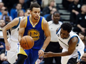 Golden State Warriors’ Stephen Curry, left, beats Minnesota Timberwolves’ Andrew Wiggins to the ball during the second half of an NBA basketball game, Thursday, Nov. 12, 2015, in Minneapolis. The Warriors won 129-116. (AP Photo/Jim Mone)