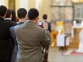 Snap-happy guests get in the way at weddings. (Fotolia)