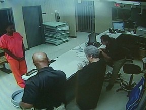 In this undated file image from video provided by the Waller County Sheriff's Department, Sandra Bland stands in front of a desk at Waller County Jail in Hempstead, Texas. Waller County, which is being sued by the family of Bland who died in the county jail in the summer of 2014, says she committed suicide because she was despondent over her relatives' refusal to quickly bail her out. The assertion is contained in a court motion in mid November 2015 asking that a lawsuit by relatives of Sandra Bland against Waller County be dismissed. (Waller County Sheriff's Department via AP, File)