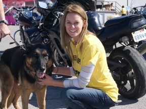 Submitted Photo
Stephanie Michelle Pignoli, owner and operator of Furballís Choice in Thurlow, pets Tucker, a  German Shepherd with Degenerative Myelopathy (DM) at the K9 Wheels For Hope at the Thurlow Community Centre. The event, which was highlighted by a 120-strong motorcycle ride, was to raise funds and awareness for the disorder.