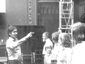 In an undated photograph, likely from drama workshops during the fall of 1976, Tomson Highway takes the role of a sergeant major in Jamie Reaney?s Wacousta! Here, his character is drilling the firing squad that is to dispatch an unfortunate British soldier who had failed to keep Fort Detroit safe from stealthy attackers such as Wacousta. (Western Archives)