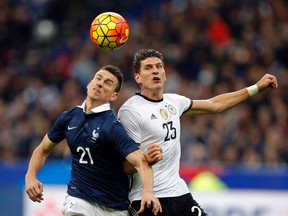 France’s Laurent Koscielny, left, challenges for the ball with Germany’s Mario Gomez at the Stade de France stadium in Saint Denis, France, Friday Nov. 13, 2015 (AP Photo/Christophe Ena)