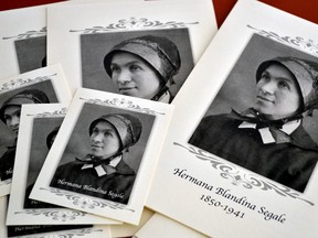 Pamphlets and prayer cards of Sister Blandina Segale sit on a table at the Catholic Center in Albuquerque, N.M. as an Archdiocese of Santa Fe panel listens to evidence about Segale on possible Sainthood on Tuesday, Aug. 25, 2015. (AP/Russell Contreras)