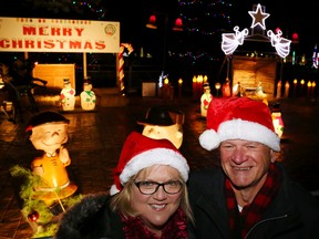 Luke Hendry/The Intelligencer
Annis and Peter Ross smile after the unveiling of this year's Christmas Lighting Extravaganza at Meyers Pier in Belleville Friday. The display began in 1958 as a memorial to local men Billy Foster and Art "Sonny" Culloden, Annis' brother, who died after a traffic accident.
