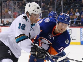 Patrick Marleau of the San Jose Sharks and Josh Bailey of the New York Islanders battle for position at the Barclays Center on October 17, 2015 in Brooklyn. (Bruce Bennett/Getty Images/AFP)