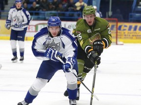 Alan Lyszczarczyk, left, of the Sudbury Wolves, and Mark Shoemaker, of the North Bay Battalion, battle for the puck during OHL action at the Sudbury Community Arena in Sudbury, Ont. on Friday November 13, 2015. John Lappa/Sudbury Star/Postmedia Network