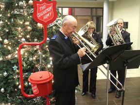 Ron Wong, left, and other members of the Salvation Army band play during a kick-off breakfast in Kingston, Ont. on Friday, Nov. 13, 2015 for the annual Christmas kettle campaign. Money raised from the fundraising drive pays for the various Salvation Army programs. Michael Lea/The Whig-Standard/Postmedia Network