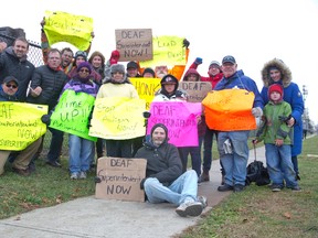 People protest outside the Robarts School For The Deaf on Highbury Avenue in London Friday. The group is upset their push to hire the first deaf superintendent of Ontario?s three schools for the deaf has been ignored. (DEREK RUTTAN, The London Free Press)