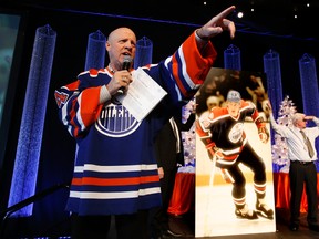 Garry Meyer, Managing Director of the Edmonton Oiler's Alumni Association, auctions off a one of a kind 8-foot tall signed Wayne Gretzky print during the 14th annual Faceoff Against Hunger Luncheon at the Shaw Conference Centre on Friday Dec 13, 2013. The event raised an estimated $150,000 to help local charities through the Edmonton Oilers Foundation. $100,000 was gifted to the Christmas Bureau at the start of the event. Tom Braid/Edmonton Sun