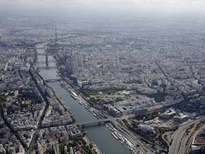 An aerial view shows the Eiffel tower, the Seine River and the Paris skyline, France, in this July 14, 2015 file photo. Gunmen and bombers attacked busy restaurants, bars and a concert hall at locations around Paris on November 13, 2015, killing dozens of people in what a shaken President Francois Hollande described as an unprecedented terrorist attack. REUTERS/Philippe Wojazer/Files