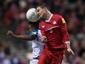 Canada’s Will Johnson, right, battles Honduras’ Bryan Acosta for the ball during 2018 World Cup qualifying action in Vancouver, B.C., on Friday November 13, 2015. (THE CANADIAN PRESS/Darryl Dyck)