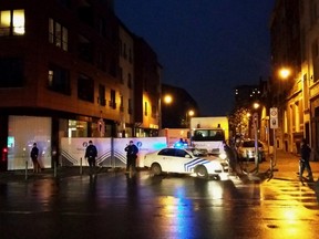 A photo taken on Nov. 14, 2015 with a mobile phone shows Belgian police blocking a street during a police raid possibly in connection with the Nov. 13 deadly attacks in Paris, in Brussels' Molenbeek district. (AFP PHOTO/BELGA/HENDRIK DEVRIENDT)