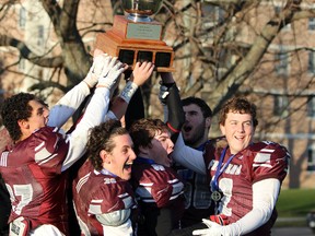 The captains of the Frontenac Falcons receive the Rob Druce Memorial Trophy after defeating the Regiopolis-Notre Dame Panthers in the Kingston Area Secondary Schools Athletic Association AAA football finals in Kingston, Ont. on Saturday November 14, 2015. Frontenac defeated  Regiopolis 35-14 to move on to OFSSA. Steph Crosier/Kingston Whig-Standard/Postmedia Network