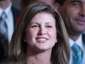 Rona Ambrose smiles as she is introduced as the interim-leader of the Conservative party following a caucus meeting Thursday Nov. 5, 2015 in Ottawa. THE CANADIAN PRESS/Adrian Wyld