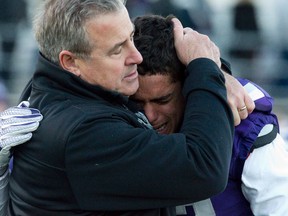 Western Mustangs head coach Greg Marshall comforts defensive back Josh Woodman after the Stangs lost the OUA Yates Cup championship football game to the Guelph Gryphons with a score of 23-17 at TD Stadium in London, Ont. on Saturday November 14, 2015. Craig Glover/The London Free Press/Postmedia Network