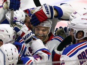 New York Rangers' Dan Boyle, centre, celebrates his shoot-out goal with teammates during overtime NHL hockey action against the Ottawa Senators, in Ottawa, on Saturday, Nov. 14, 2015. The Rangers beat the Senators 2-1. THE CANADIAN PRESS/Fred Chartrand