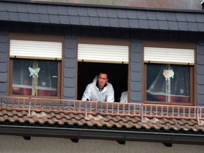 A crime scene specialist of the police looks out of window of an apartment on Nov. 13, 2015 in Wallenfels, southern Germany, where the bodies of eight infants were discovered the day before.  (AFP PHOTO/MARCUS SCHEIDEL)