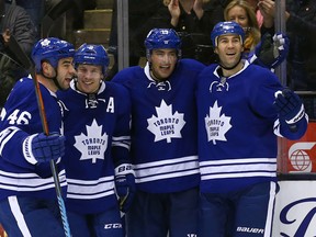 Joffrey Lupul of the Toronto Maple Leafs celebrates his goal with Roman Polak, Matt Hunwick, and Daniel Winnik against the Vancouver Canucks during NHL action at the Air Canada Centre in Toronto on Saturday, November 14, 2015. (Dave Abel/Toronto Sun/Postmedia Network)