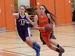 Kennedy Cashmore, right, of Lasalle Lancers, drives to the basket while Nicole Conlin, of Lo-Ellen Knights, attempts to stop her during girls division I basketball final action at Lasalle Secondary School in Sudbury, Ont. on Saturday November 14, 2015. John Lappa/Sudbury Star/Postmedia Network