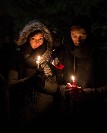 Pauline Just and Alexandre Chavand are students from France attending university in Ottawa. They were amongst many at a vigil outside of the French Embassy in Ottawa for the victims of the terrorist attack in their homeland.Saturday November 14, 2015. Errol McGihon/Ottawa Sun/Postmedia Network