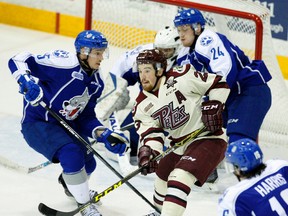 Peterborough Petes' Hunter Garlent is checked between Sudbury Wolves' Chad Heffernan, left, and Cole Mayo during first period OHL action on Saturday November 14, 2015 at the Memorial Centre in Peterborough, Ont. Clifford Skarstedt/Peterborough Examiner/Postmedia Network