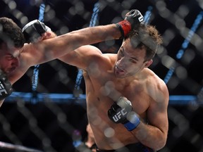 Anthony Perosh, left, and Gian Villante compete during their UFC 193 light heavyweight bought in Melbourne, Australia, on Sunday, Nov. 15, 2015. (AP/Andy Brownbill)