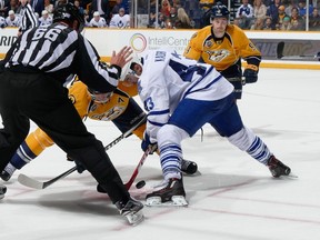 Nazem Kadri of the Toronto Maple Leafs takes a faceoff against Mike Fisher of the Nashville Predators during an NHL game at Bridgestone Arena in Nashville on Nov. 12, 2015. (FREDERICK BREEDON/Getty Images/AFP)
== FOR NEWSPAPERS, INTERNET, TELCOS & TELEVISION USE ONLY ==