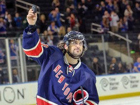 New York Rangers right winger Mats Zuccarello holds a puck after his team's 3-1 victory over the Toronto Maple Leafs on Oct. 30, 2015, at Madison Square Garden in New York. Zuccarello had a hat trick in the game. (VINCENT CARCHIETTA/USA TODAY Sports)