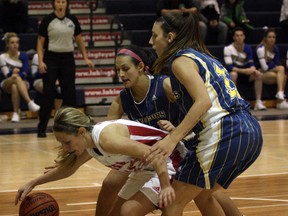 Laurentian's Mackenzie Robinson (12) and Adriane Bruni (11) double-team York's Sandra Nagowska (11) during OUA women's basketball action at the Ben Avery Gym in Sudbury on Saturday. Ben Leeson/The Sudbury Star/Postmedia Network