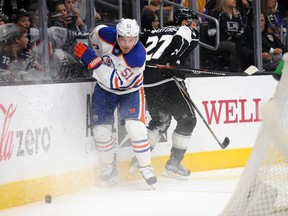 November 14, 2015; Los Angeles, CA, USA; Edmonton Oilers center Anton Lander (51) plays for the puck against Los Angeles Kings defenseman Alec Martinez (27) in the first period at Staples Center. 
Gary A. Vasquez-USA TODAY Sports