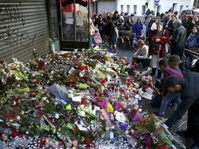 People pay their respect at one of the attack sites in Paris, Nov. 15, 2015.    REUTERS/Benoit Tessier