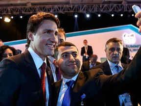 Prime Minister Justin Trudeau (L) poses for a selfie for a delegate during the L20/B20 meeting at the Group of 20 (G20) summit in the Mediterranean resort city of Antalya, Turkey, Nov. 15, 2015.  REUTERS/Ercin Top/Pool