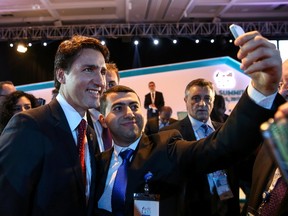 Prime Minister Justin Trudeau poses for a selfie for a delegate during a meeting at the G-20 summit in the Mediterranean resort city of Antalya, Turkey. (REUTERS)
