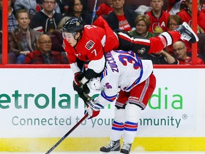 Ottawa Senators centre Kyle Turris (7) is checked by New York Rangers right wing Mats Zuccarello (36) during NHL action in Ottawa on Saturday Nov. 14, 2015. Turris was hurt on the play and may miss Monday's game against the Wings as a result. (Errol McGihon/Ottawa Sun/Postmedia Network)