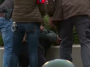 Belgian police detaining a suspect during a raid in the Molenbeek quarter of Brussels in this still image taken from video made available on Nov. 15, 2015.  Belgian police arrested three people on Saturday in raids in a poor, immigrant quarter of Brussels as they pursued emerging links between the Paris attacks and an Islamist bastion in France's northern neighbour.  REUTERS/RTL Belgium
