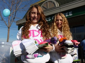 Carly Goldhar (L) and Charley Rangel,  both 10, are collecting socks for the homeless. They hope to collect 5,000 pairs this winter. (Maryam Shah, Toronto Sun)