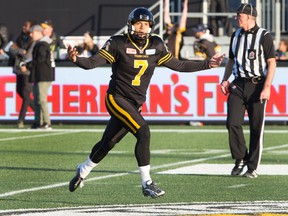 Hamilton Tiger-Cats kicker Justin Medlock celebrates after kicking the winning field goal during the second-half of CFL east semi-final football action in Hamilton on Nov. 15, 2015. (THE CANADIAN PRESS/Peter Power)