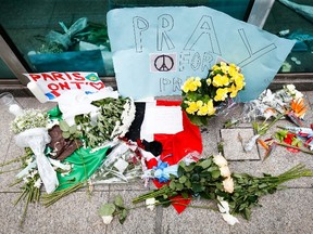 Flowers are laid outside the French Consulate in Sao Paulo, Brazil on November 15, 2015, in homage to the victims of deadly attacks in Paris that killed at least 129 people. (AFP PHOTO/ALEXANDRE SCHNEIDER)