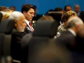 CanadaÃ•s Prime Minister Justin Trudeau (C) participates in a working session on the global economy with fellow world leaders at the start of the G20 summit at the Regnum Carya Resort in Antalya, Turkey, November 15, 2015. REUTERS/Jonathan Ernst
