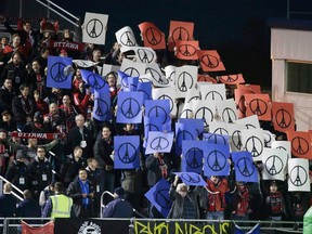 Fans hold up signs in solidarity with the victims of the Paris attacks during the New York Cosmos vs Ottawa Fury FC, NASL Championship Finals in Hempstead, New York, November 15, 2015.  REUTERS/Brendan McDermid