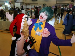 Harley Quinn (Keri Foley) tries to kiss The Joker (Rob Charming) at Quinte Mini Con in Belleville, Ont. Saturday, Nov. 14, 2015. Costume-related activities accounted for about half of the attractions at the fan convention.