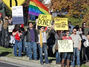 People gather for a mass resignation from the Church of Jesus Christ of Latter-day Saints Saturday, Nov. 14, 2015, in Salt Lake City. A day after the Mormon church stood behind its new rules targeting gay members and their children, while issuing clarifications, hundreds held a rally in Salt Lake City to protest their displeasure with the policy changes. (AP Photo/Rick Bowmer)