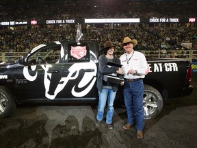 Rodeo Manager for the Alberta Ram Dealers Martin Sobie presents Marissa Wheeler with a 2015 RAM 1500 Sport that she won during the final day of the Canadian Finals Rodeo at Rexall Place, in Edmonton. on Sunday..( David Bloom/Edmonton Sun/Postmedia Network)