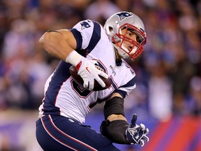 Rob Gronkowski of the New England Patriots avoids the tackle and carries the ball in for a touchdown in the fourth quarter against the New York Giants at MetLife Stadium in East Rutherford on Nov. 15, 2015. (Elsa/Getty Images/AFP)