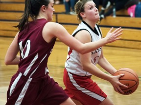 A Bayside Devil ballcarrier drives the hoop under pressure from a PECI Panthers defender during the Bay of Quinte senior girls basketball final Saturday at Loyalist College. (Isaac Paul for The Intelligencer)